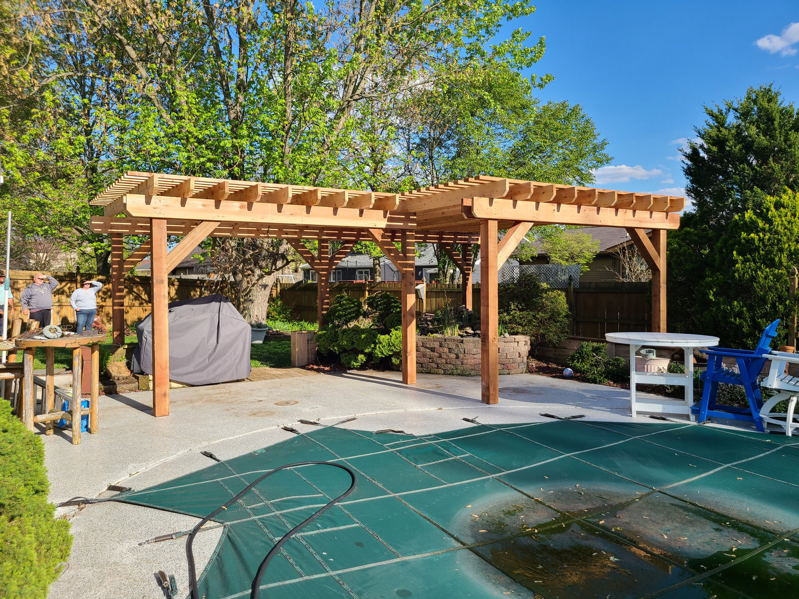 Cedar pergola over a poolside patio built by T&J Construction
