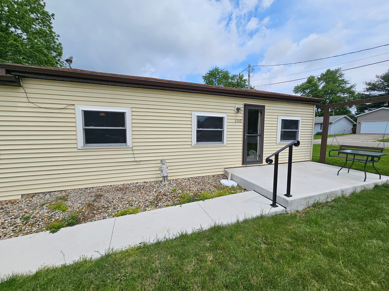 New concrete sidewalk, steps, and handrail poured by a concrete contractor
