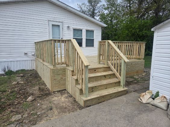New pressure treated wood deck with wrap around railing and stairs on a Northern Indiana home