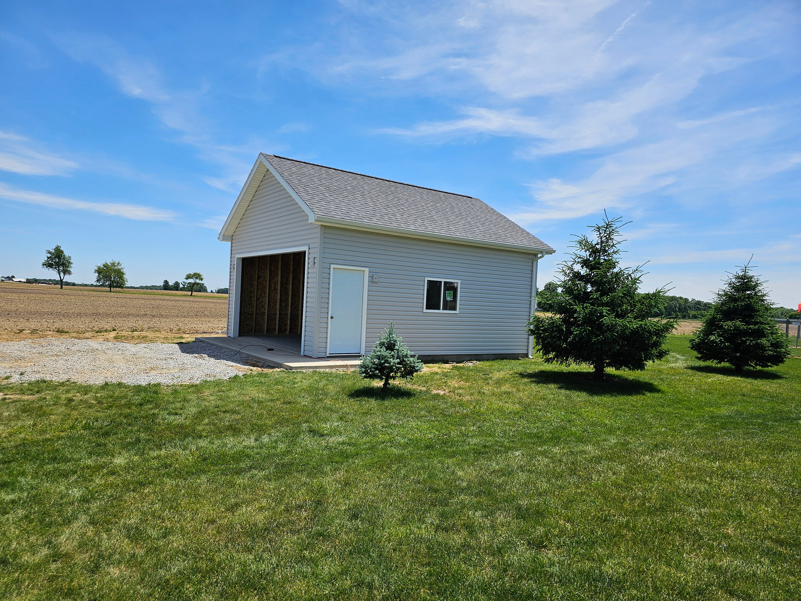 Detached garage with vinyl siding and concrete approach built in Northern Indiana