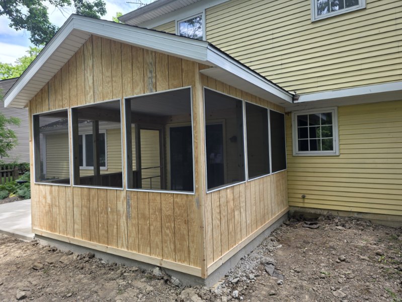 New screened porch addition with cedar tongue and groove siding on a Northern Indiana home